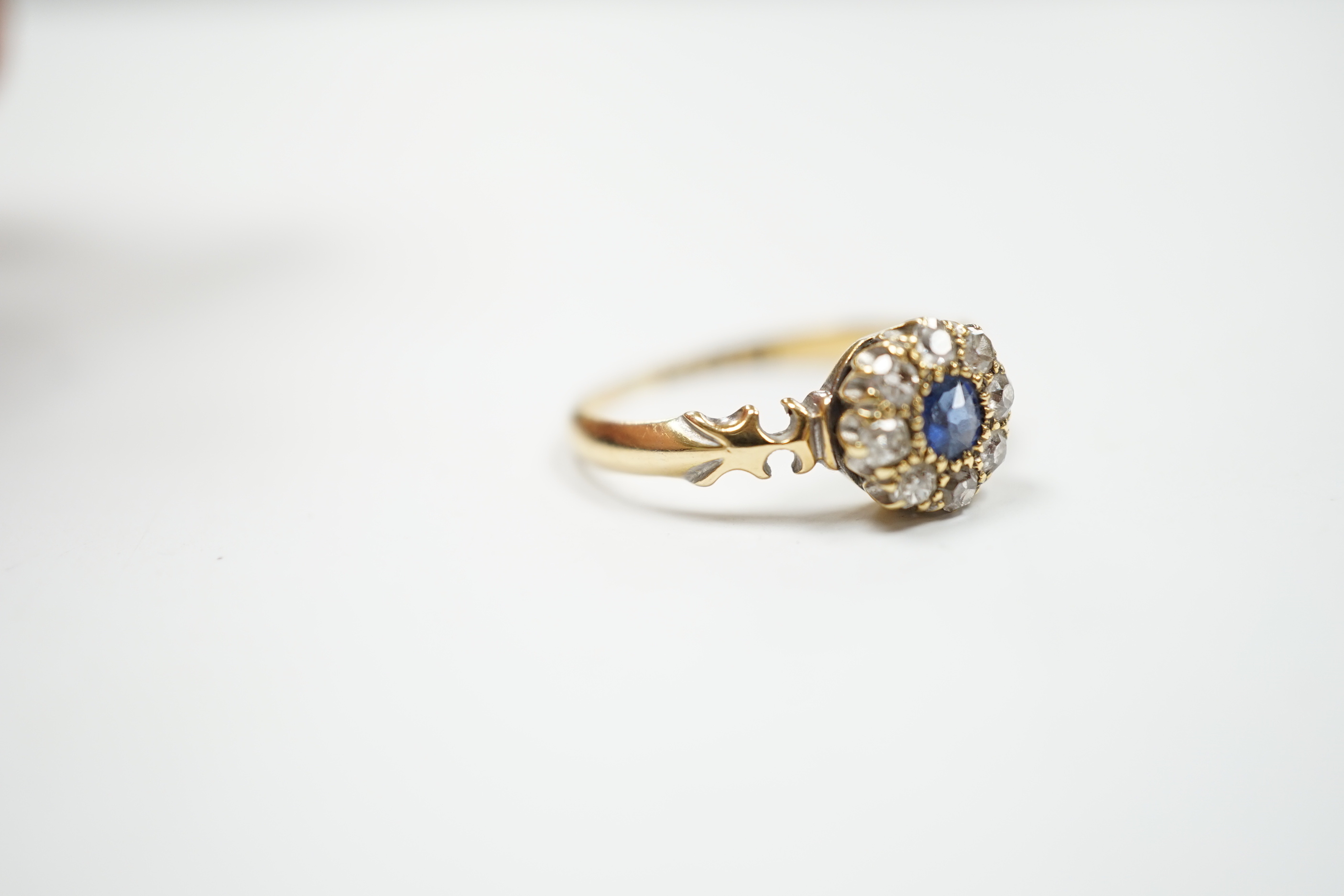 A late Victorian 18ct gold, sapphire and diamond set circular cluster ring, Birmingham, 1889, size M, gross weight 2.7 grams.